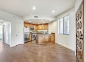 Thumbnail 48 of 88 - an empty kitchen with wooden cabinets and a stainless steel refrigerator