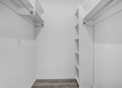 Thumbnail 42 of 42 - a room with white walls and a closet with shelves