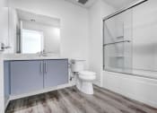 Thumbnail 40 of 42 - a white bathroom with a toilet and a shower