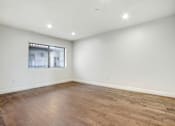 Thumbnail 49 of 88 - an empty living room with wood flooring and a window