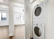 Thumbnail 53 of 88 - a washer and dryer in a white laundry room
