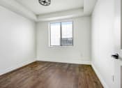 Thumbnail 50 of 88 - an empty living room with wood floors and a window