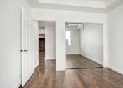Thumbnail 52 of 88 - an empty living room with a mirrored closet door