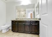 Thumbnail 57 of 88 - a bathroom with a toilet and a sink and a mirror