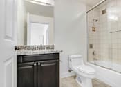 Thumbnail 55 of 88 - a bathroom with a sink toilet and a shower