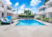 Thumbnail 24 of 102 - a swimming pool in the middle of a white apartment building