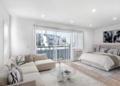 Thumbnail 14 of 102 - a white bedroom with a bed and a couch and a table