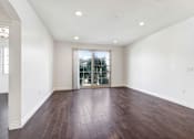 Thumbnail 64 of 88 - an empty living room with white walls and a sliding glass door