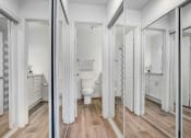 Thumbnail 19 of 102 - a white bathroom with a toilet and a mirror