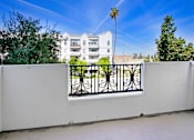 Thumbnail 61 of 88 - a balcony with a fence and a building in the background