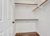 Thumbnail 66 of 88 - a walk in closet with white walls and a white closet with a white door