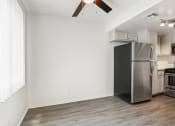 Thumbnail 22 of 94 - an empty living room with a stainless steel refrigerator