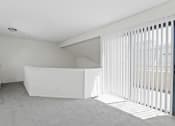 Thumbnail 30 of 94 - an empty living room with white blinds and a window