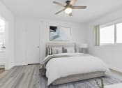 Thumbnail 2 of 23 - a bedroom with a large bed and a ceiling fan