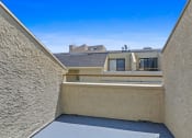 Thumbnail 27 of 94 - a balcony with a view of a building and a blue sky