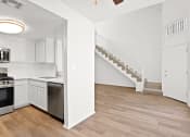 Thumbnail 14 of 94 - an open kitchen and living room with a staircase in a home