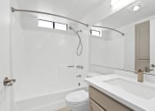 Thumbnail 20 of 94 - a bathroom with a sink toilet and a shower