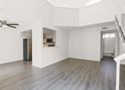 Thumbnail 24 of 94 - an empty living room with white walls and a ceiling fan