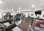 Thumbnail 6 of 10 - a gym with treadmills and other exercise equipment