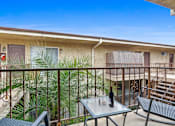 Thumbnail 6 of 22 - a balcony with a table and chairs and a bottle of wine on it