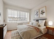 Thumbnail 8 of 22 - a bedroom with a large bed and a window