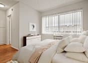 Thumbnail 7 of 22 - a bedroom with white bedding and pillows and a window