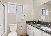Thumbnail 9 of 22 - a bathroom with a toilet and a sink and a shower