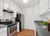 Thumbnail 1 of 22 - a kitchen with white cabinets and stainless steel appliances