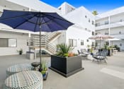 Thumbnail 37 of 45 - a patio with tables and umbrellas and chairs and a staircase
