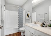 Thumbnail 18 of 64 - a bathroom with a shower and a sink and a toilet