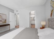 Thumbnail 15 of 64 - a bedroom with a large bed and a door to a bathroom