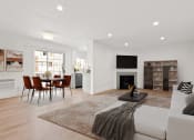 Thumbnail 14 of 32 - a living room with a white couch and a table with chairs