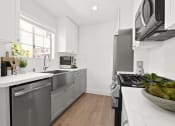 Thumbnail 15 of 32 - a kitchen with stainless steel appliances and a large window