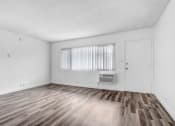 Thumbnail 19 of 73 - the living room of an apartment with wood flooring and a window