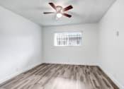 Thumbnail 20 of 73 - an empty living room with a ceiling fan and a window