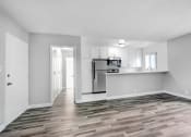 Thumbnail 13 of 73 - the living room and kitchen of an apartment with a hard wood floor