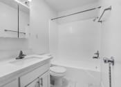 Thumbnail 16 of 73 - a white bathroom with a sink toilet and shower