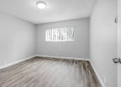Thumbnail 15 of 73 - the living room of an empty house with wood flooring and a window