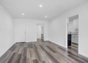 Thumbnail 3 of 73 - a living room with white walls and wood floors