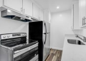 Thumbnail 2 of 73 - a kitchen with white cabinets and stainless steel appliances