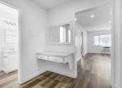 Thumbnail 5 of 73 - a white bathroom with a vanity and a mirror