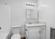 Thumbnail 11 of 73 - a white bathroom with a toilet and a sink