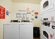 Thumbnail 23 of 25 - a laundry room with two washes and two washing machines