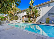 Thumbnail 21 of 25 - a swimming pool with a building in the background