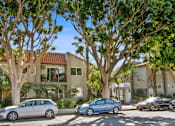 Thumbnail 18 of 25 - the front of a house with cars parked in front of it