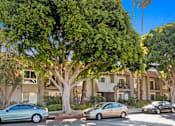 Thumbnail 17 of 24 - a group of cars parked in front of an apartment building
