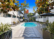 Thumbnail 18 of 24 - a swimming pool in the middle of a hotel courtyard