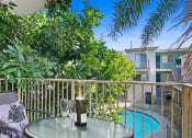Thumbnail 5 of 34 - a bottle of wine on a table on a balcony overlooking a swimming pool