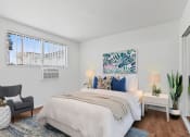 Thumbnail 6 of 34 - a bedroom with a large bed and a window