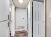Thumbnail 45 of 64 - an empty hallway with a white door and a door to a closet
